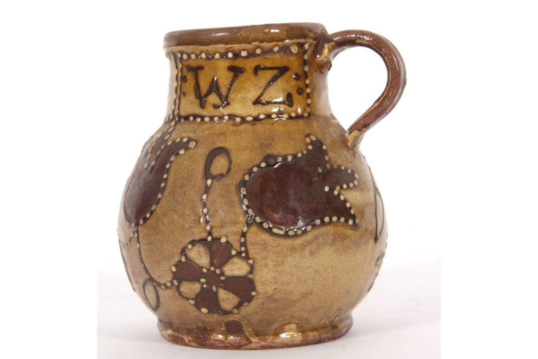 An early 18th Century pottery mug, possibly Devon slip ware decorated with tulips and dated 1743, - Image 4 of 7