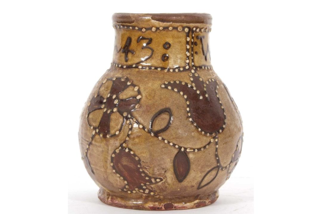 An early 18th Century pottery mug, possibly Devon slip ware decorated with tulips and dated 1743, - Image 3 of 7