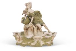 A Royal Dux Art Nouveau centrepiece shaped as a maiden above a bowl decorated with lillies, pink