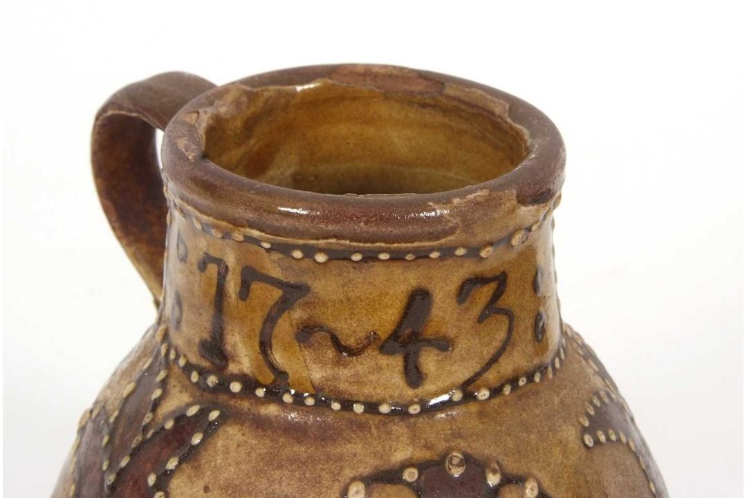 An early 18th Century pottery mug, possibly Devon slip ware decorated with tulips and dated 1743, - Image 7 of 7