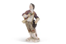 A Meissen figure of a gallant holding a posie of flowers, late 19th/20th Century, cross swords