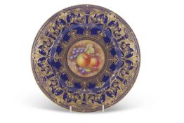 A Royal Worcester cabinet plate, the blue ground with tooled gilt decoration, the central panel