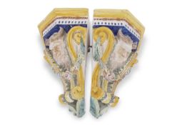 Two Italian faience style corner shelves, both decorated in Majolica glazes with satyrs, 35cm high
