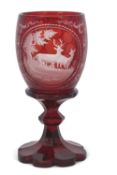 A 19th Century Bohemian ruby glass vase, engraved with deer in a landscape, 22cm high