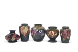 Group of five mid 20th Century Moorcroft vases, four with floral designs including Orchid and Leaf