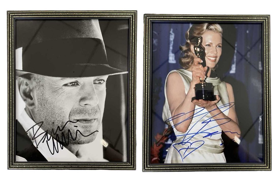 A pair of framed and glazed colour photographs bearing the signatures of Kim Basinger and Bruce