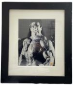 A framed black and white photograph bearing the signature of American actor and bodybuilder, Lou