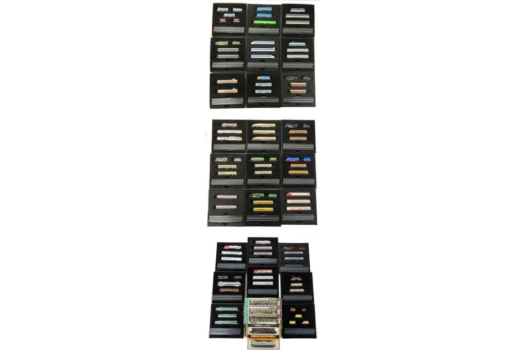 A collection of various boxed Atlas Editions 1:220 scale minitranis, together with others