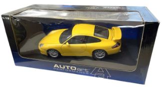 A boxed AutoArt 1:18 scale Porsche 911 GT3 in bright yellow