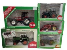 Five boxed Siku 1:32 scale tractor models, to include: - 3460 Hanomag R45 - 2868 Massey Ferguson