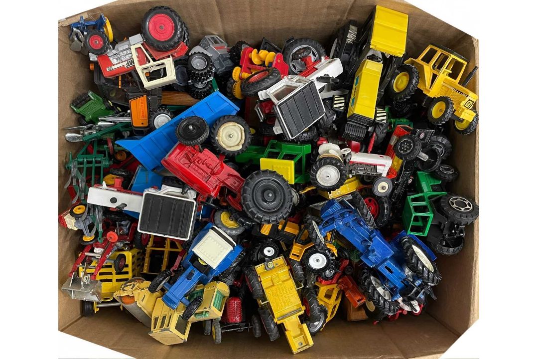 A large box of various die-cast tractor models of various makes
