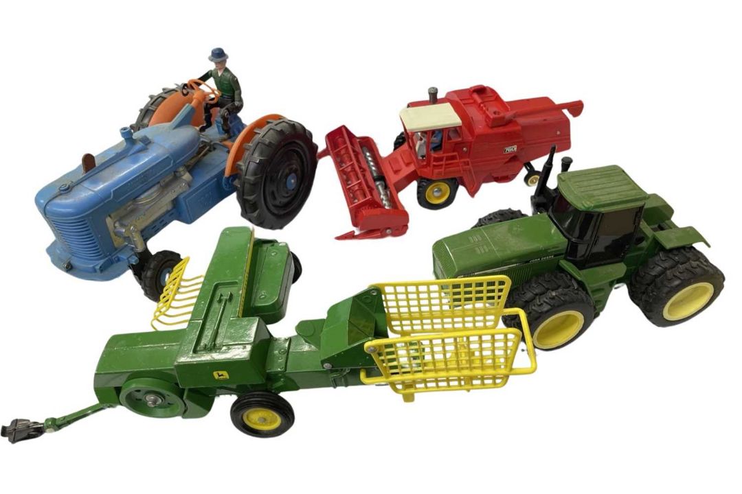 Four large scale model agricultural vehicles, to include: - John Deere tractor - Britains 1978