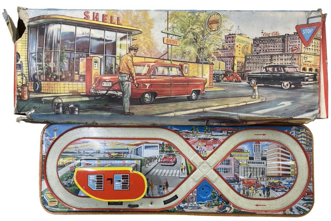 A vintage Welsotoys tinplate Shell garage and car track (losses and tears to box, missing car)