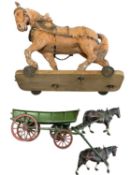 A composite model horse on wooden wheeled base (a/f), together with a die-cast pony trap with 2