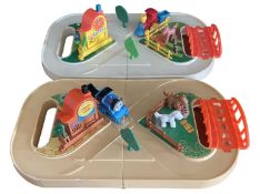 A pair of vintage TOMY Tote-Along-Train sets