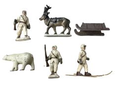 An interesting group of die-cast figures, formed as Alaskan hunters, polar bear and reindeer with