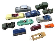 A collection of playworn die-cast toy cars, mostly Dinky