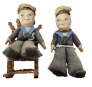 A pair of vintage cloth Norah Wellings-style sailor dolls, sat on wooden rocking chairs