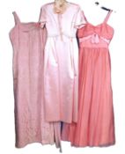A mid 20th Century pink satin bridesmaids dress, with white daisy lace detail and headress, together