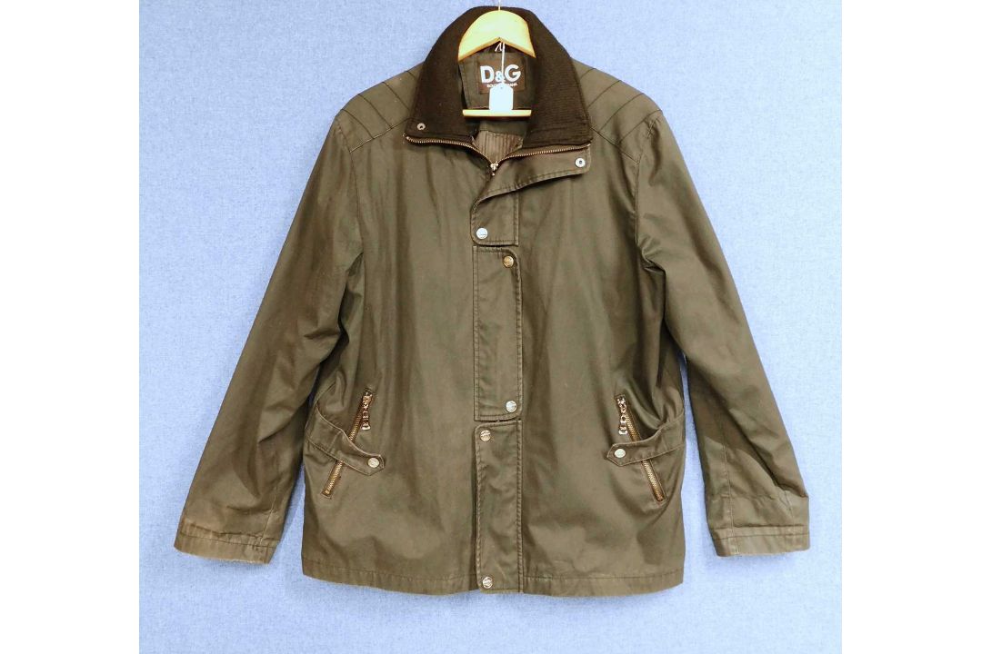 A lady's Dolce & Gabbana rain jacket with zip front overlapping popper details, zip pockets and - Image 1 of 7