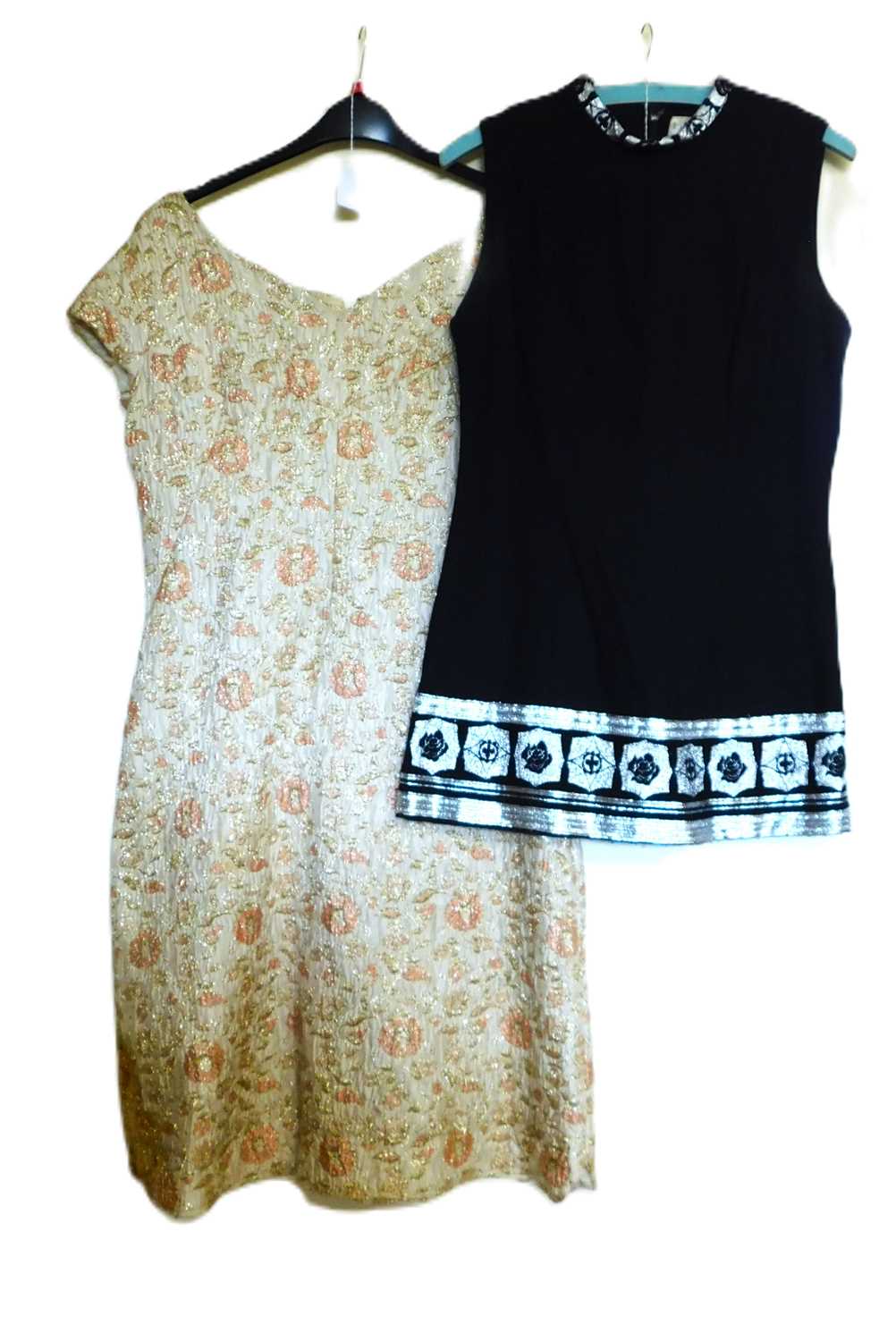 Two c.1960's dresses, to include a black and silver sleeveless shift minidress by Hershelle and a