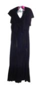 A black velvet evening gown, the sleeveless bias cut V-neck gown with matching shrug and long velvet