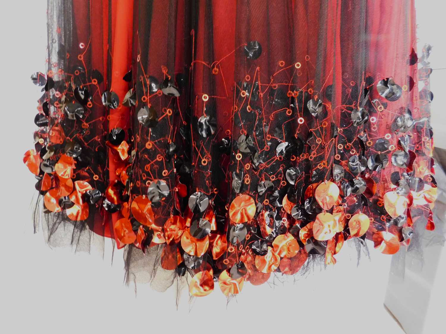 A red and black gown, the red silk with black net overlay, sleeveless with ruched bust and sequinned - Image 4 of 5