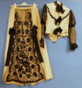 A lady's early 20th Century pale yellow and black jacket and similar skirt, button fronted with