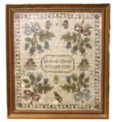 An early Victorian sampler, with floral motifs to each corner and floral border, with central