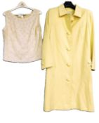 A mid 20th Century yellow coat by Jean Patou, Paris, single breasted with back pleats and button