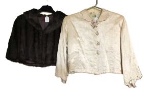 A mid 20th century lady's satin cropped jacket, together with a taupe coloured fur shoulder cape, (