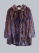 A lady's mink jacket, single breasted with rounded collar and side pockets, labelled 'Norwich Fur