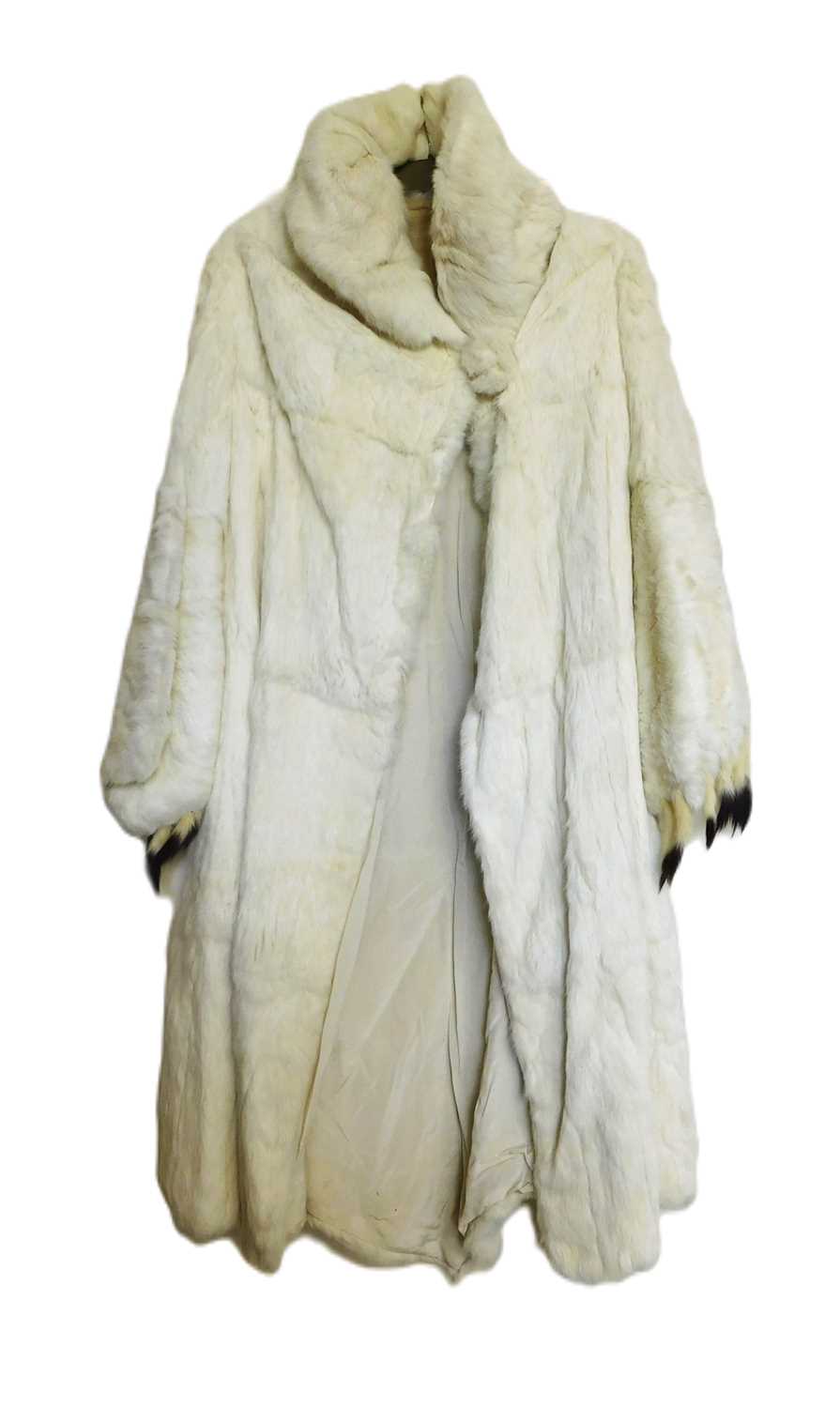 A lady's full length cream fur coat, with high turn up collar and balloon cuffed sleeves with