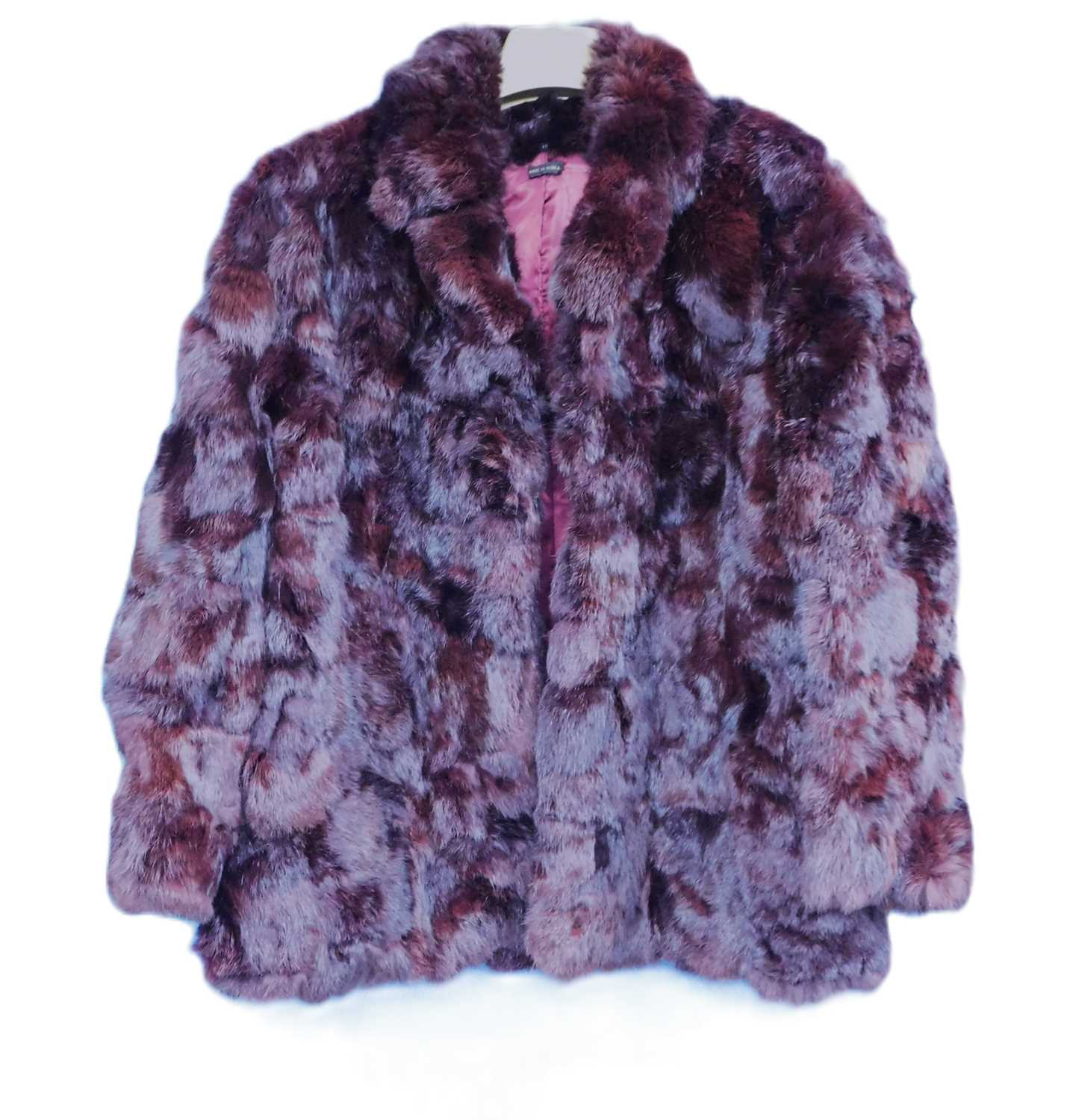 A ladies burgundy fur jacket, single breasted with side slip pockets, size 18