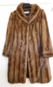 A lady's full length fur coat, with two hook fastening and side slit pockets