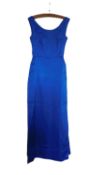 A mid 20th century evening gown, the custom made blue satin sleeveless shift with deep V-back and