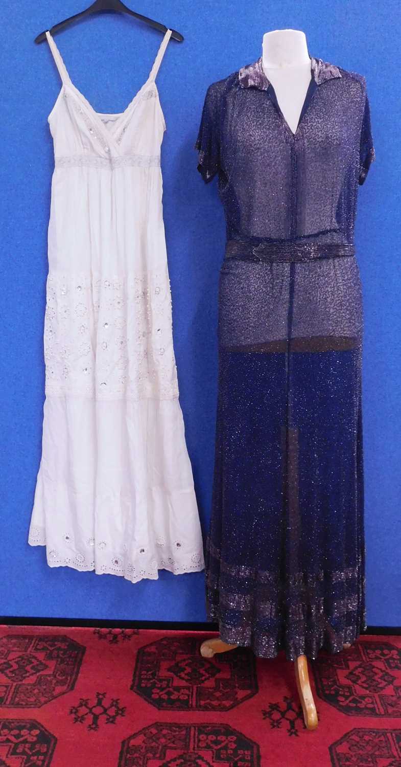 A navy blue chiffon heavily beaded dress with matching tie belt, with V-neck and collar with bugle