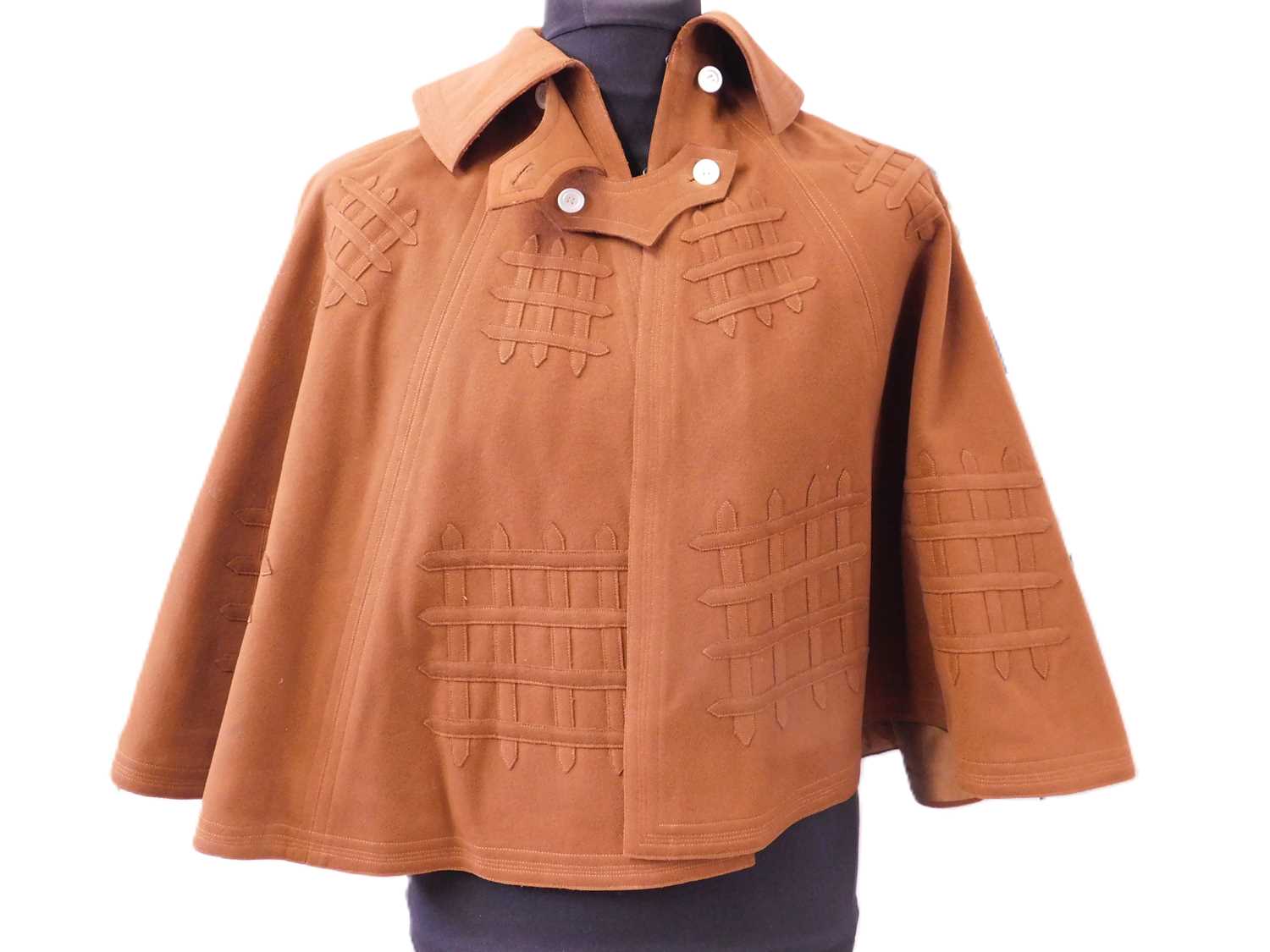 An early 20th century lady's brown felt cape, with double buckle fastening to neck and portcullis