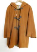 A mid 20th century Italian wool hooded swing coat by Mani, single breasted with faux horn duffle