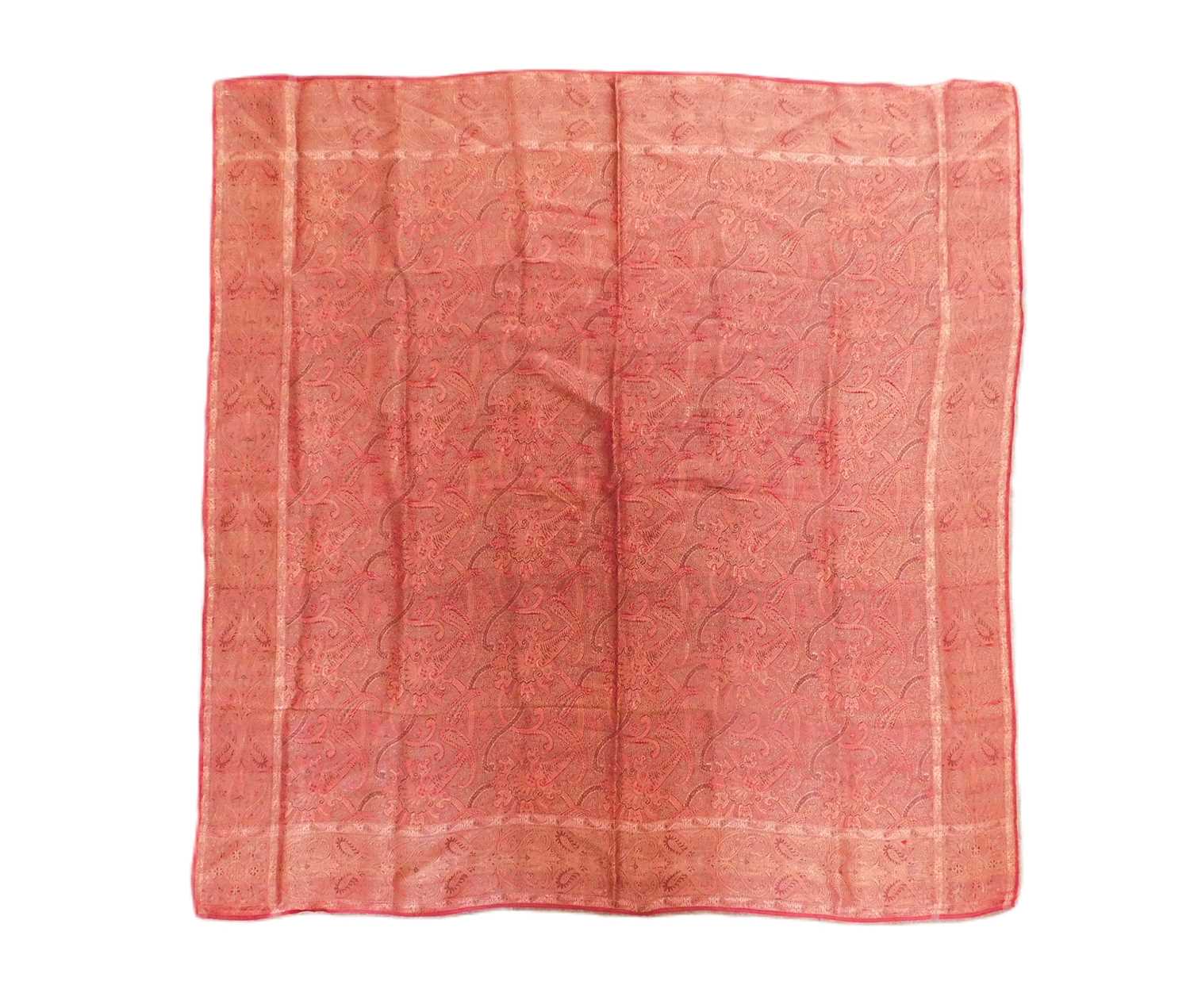 A Norwich silk shawl, in red paisley pattern, approx. 87 x 89cm edges slightly frayed but overall
