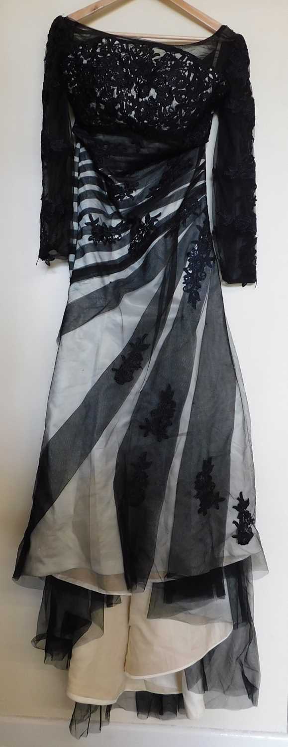 A black and cream gown by Dylan Queen, the cream dress with black net and lace overlay, moulded