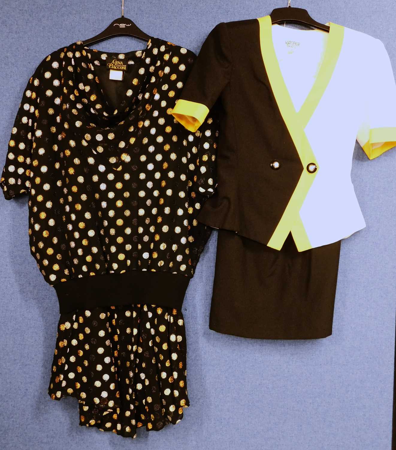 Two 1980's lady's suits, to include a black, white and yellow short sleeved skirt suit by Kasper