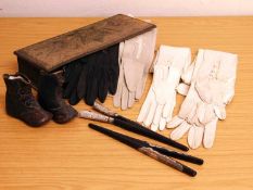 A crewel work glove box and a quantity of gloves and two pairs of silver topped glove stretchers,