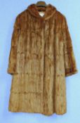 A lady's brown three quarter length mink? fur coat by Norwich Fur Co with hook fastening