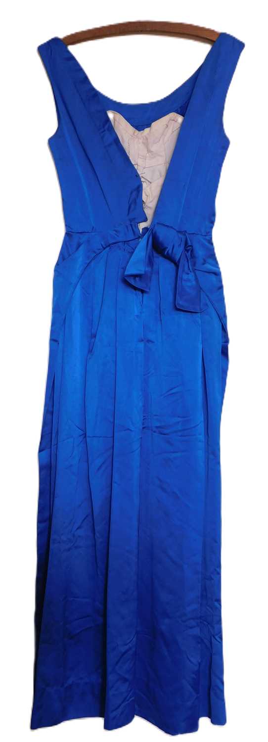 A mid 20th century evening gown, the custom made blue satin sleeveless shift with deep V-back and - Image 2 of 6