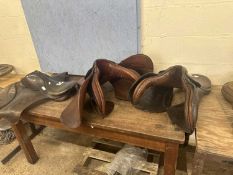 Three horse saddles