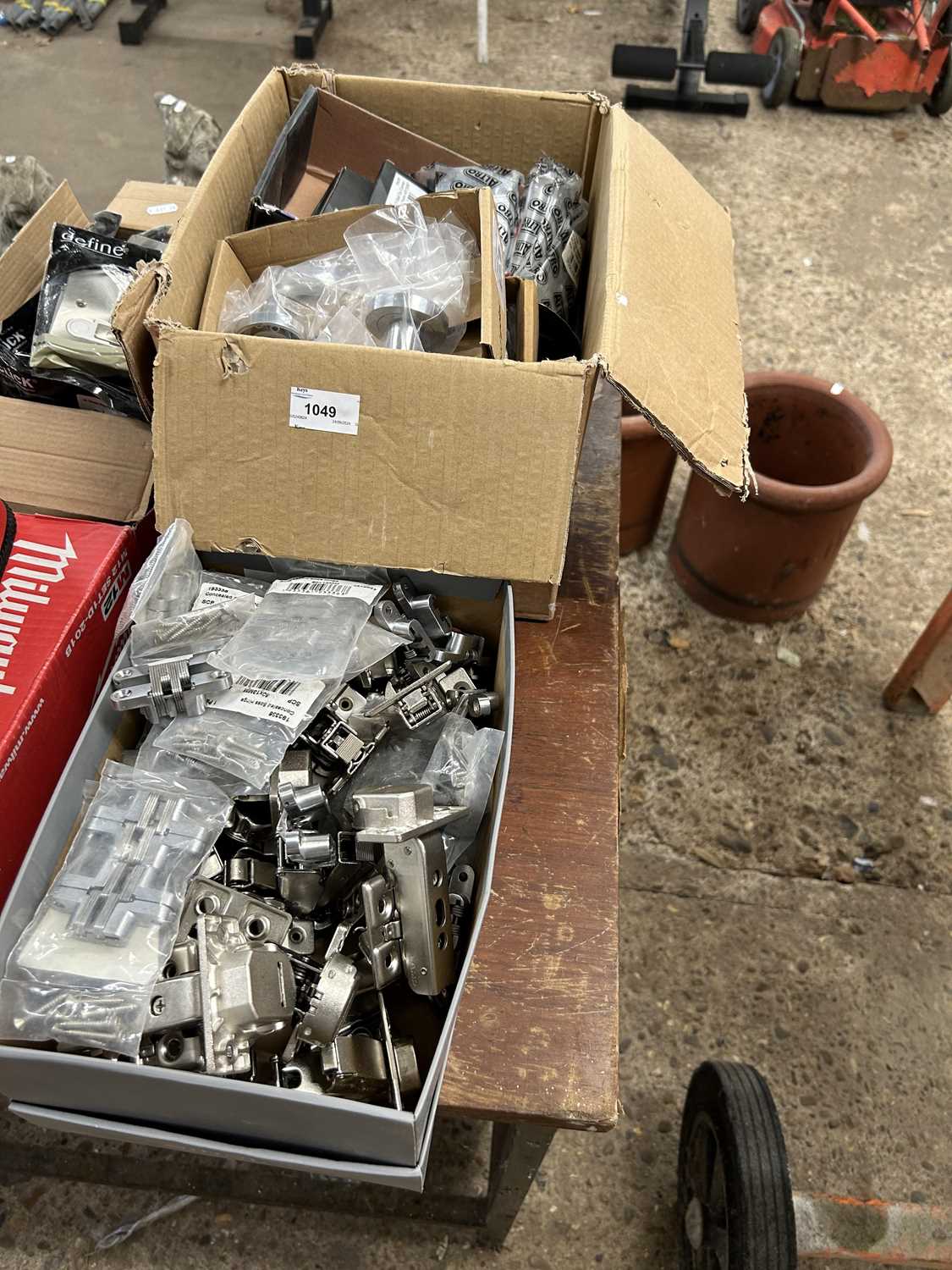 Three boxes of mixed items to include plugs, door handles, brackets etc