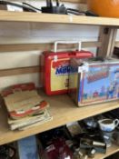 Two lunch boxes, AA badge and maps