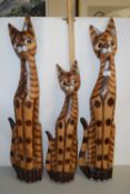 Three wooden model cats