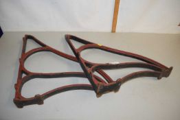 A pair of cast iron wall brackets or bench frame